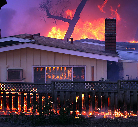 A home goes up in flames near Fallbrook, Calif., on Monday.