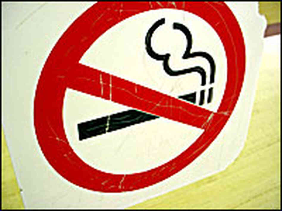 A no smoking symbol hangs on a wall. A no smoking symbol hangs on a wall.