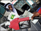 A pump attendant replaces the nozzle at a fuel station in Singapore, 26 October 2007 A pump attendant replaces the nozzle at a fuel station in Singapore, 26 October 2007
