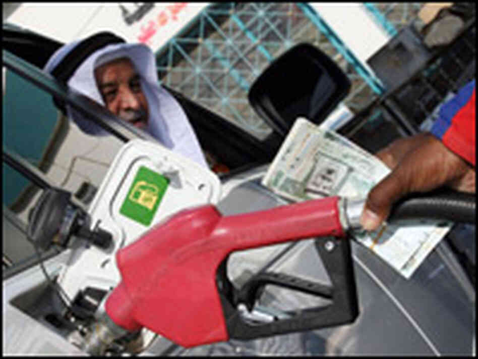 A pump attendant replaces the nozzle at a fuel station in Singapore, 26 October 2007 A pump attendant replaces the nozzle at a fuel station in Singapore, 26 October 2007