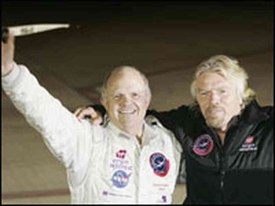 Steve Fossett, left, and Sir Richard Branson wave to reporters in Feb. 2006