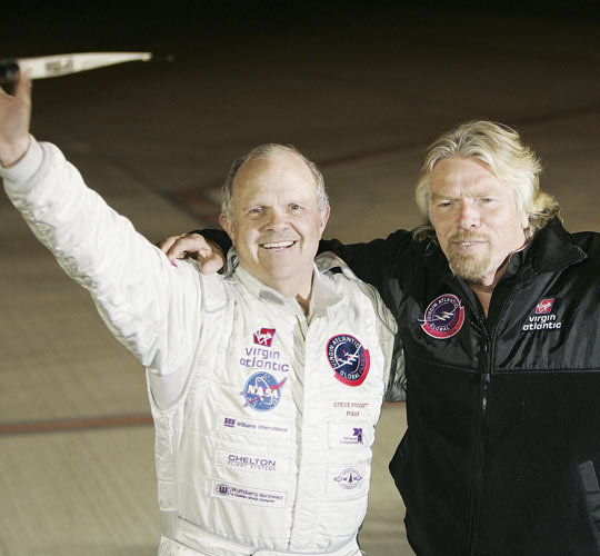 Steve Fossett, left, and Sir Richard Branson wave to reporters in Feb. 2006