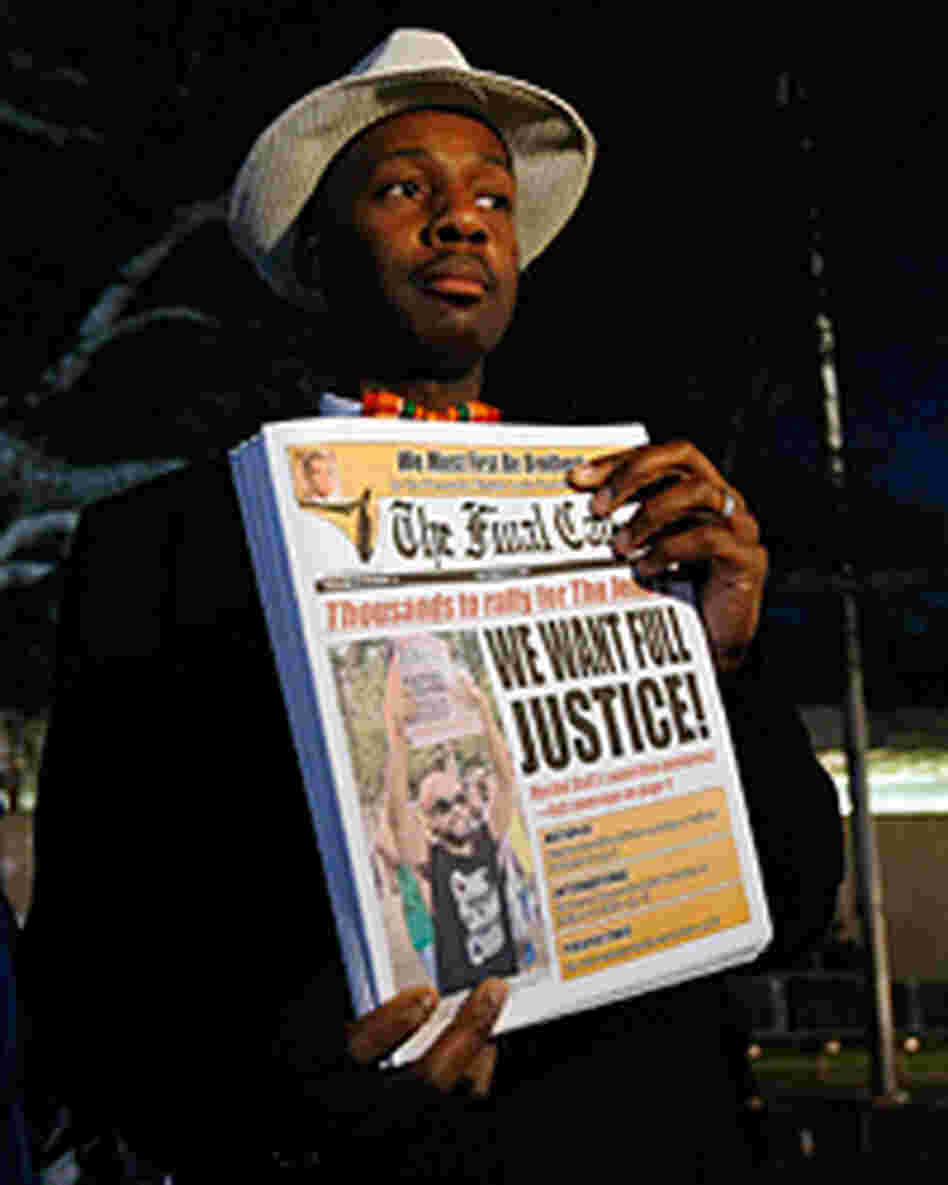 A man holds a newspaper before the start of a civil rights march in Jena, La., Thursday. A man holds a newspaper before the start of a civil rights march in Jena, La., Thursday.