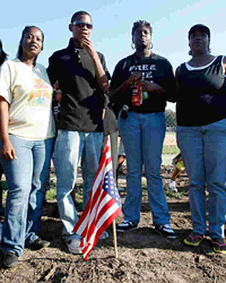 Protesters gather on the spot where a tree once stood on the Jena High School campus. Protesters gather on the spot where a tree once stood on the Jena High School campus.