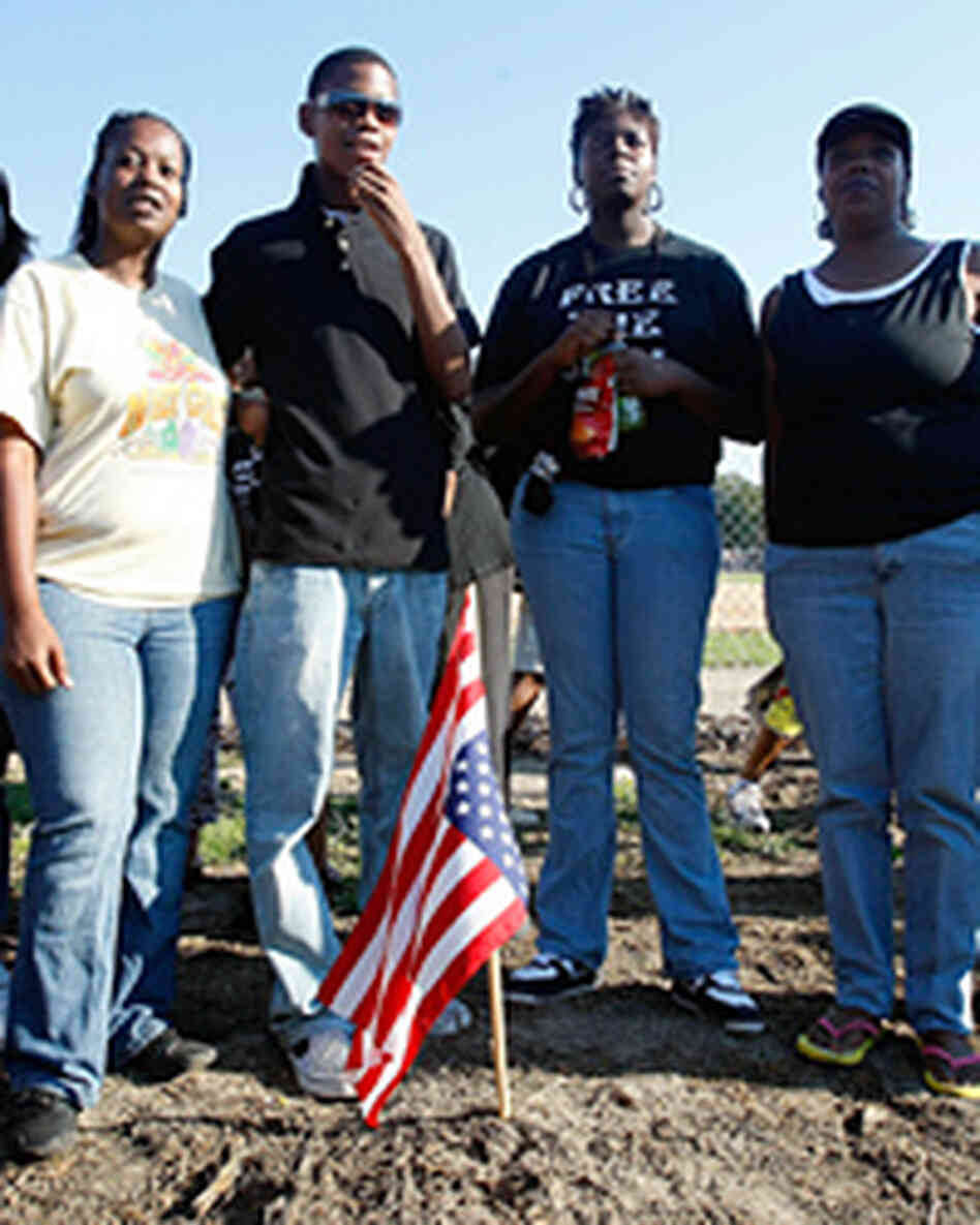 Protesters gather on the spot where a tree once stood on the Jena High School campus. Protesters gather on the spot where a tree once stood on the Jena High School campus.