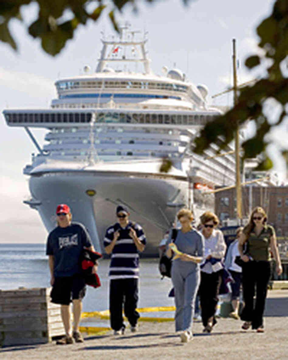 Tourists walk along the waterfront near the cruise ship Ocean Princess in Halifax, Nova Scotia. Tourists walk along the waterfront near the cruise ship Ocean Princess in Halifax, Nova Scotia.