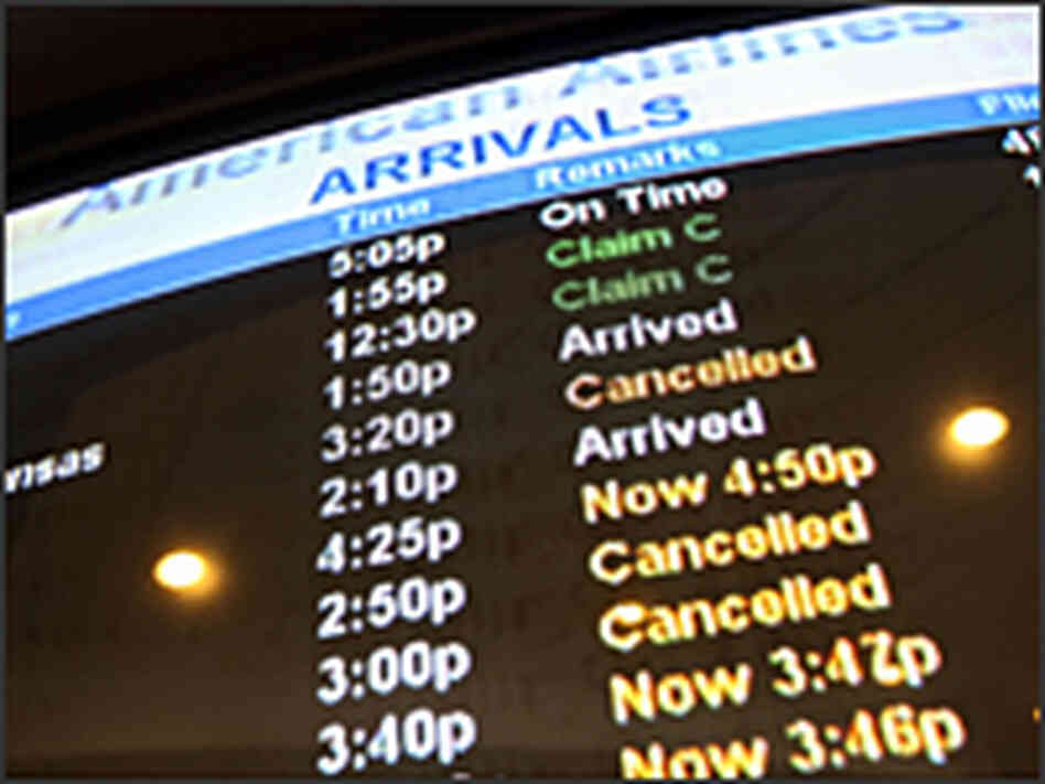 An American Airlines arrivals list. The airline has canceled around 2,500 flights since Tuesday
