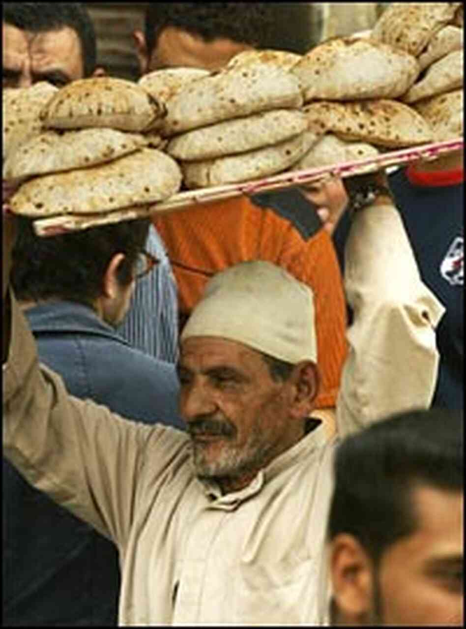 A vendor carries a rack of bread in Mahalla, Egypt.