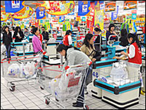 Chinese shoppers stand at the check-out counters inside a Carrefour supermarket in Shanghai on April 15, 2008. As China's population and national wealth grow, food costs — and inflation — have been rising.