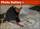 Photo gallery showing a sawdust carpet made in honor of the pope's visit.