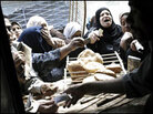 Customers compete to buy the next batch of fresh bread at a subsidized baker in Cairo, Egypt Customers compete to buy the next batch of fresh bread at a subsidized baker in Cairo, Egypt