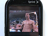 A video image of swimmer Michael Phelps on a cell phone.