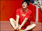 China's Liu Xiang sits on the ground after withdrawing from the 110-meter hurdles. China's Liu Xiang sits on the ground after withdrawing from the 110-meter hurdles.