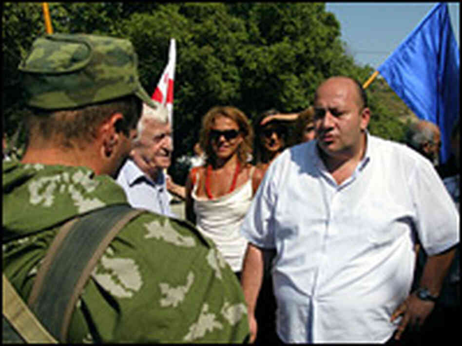 A Georgian protester confronts a Russian army officer at a checkpoint near Tbilisi.