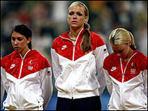 Andrea Duran (from left), Jennie Finch and Caitlin Lowe of the United States prepare to receive their silver medals after their team lost, 3-1, to Japan during the women's final medal softball game in Beijing.