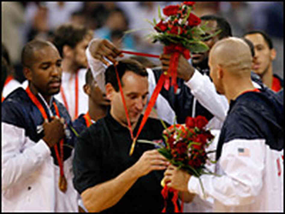 Head coach Mike Krzyzewski of the United States receives a gold medal