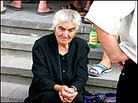 An elderly woman waits on the steps of Gori City Hall. An elderly woman waits on the steps of Gori City Hall.