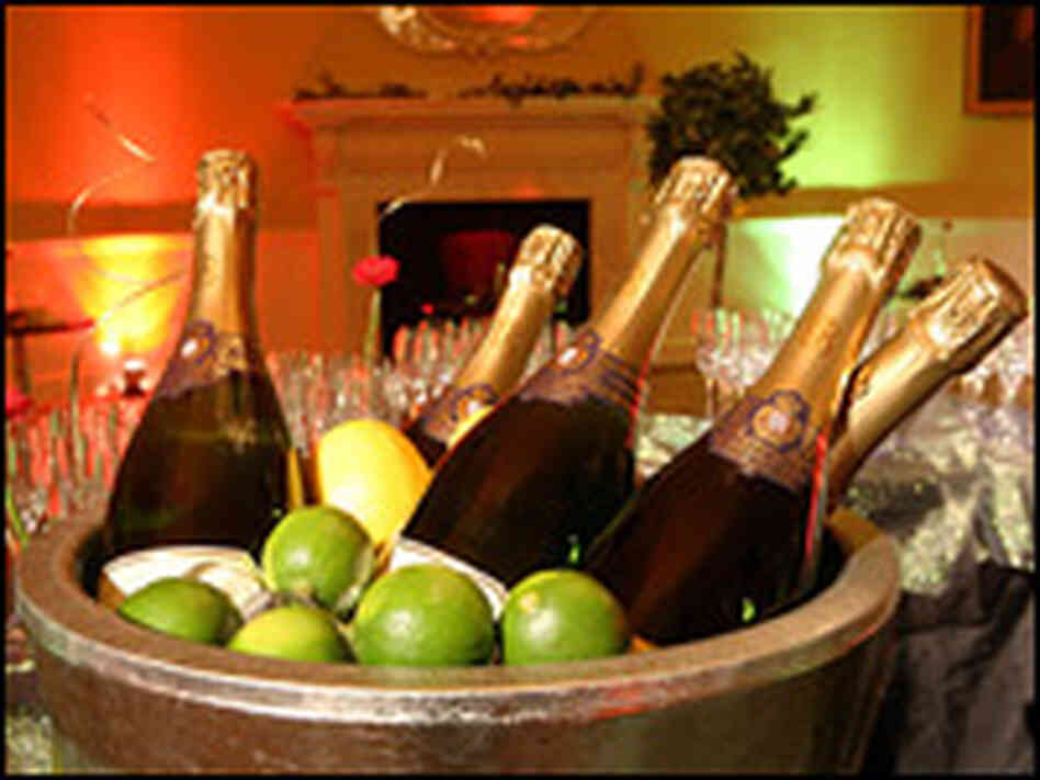 A bucket of champagne awaits guests at a formal office Christmas dinner.