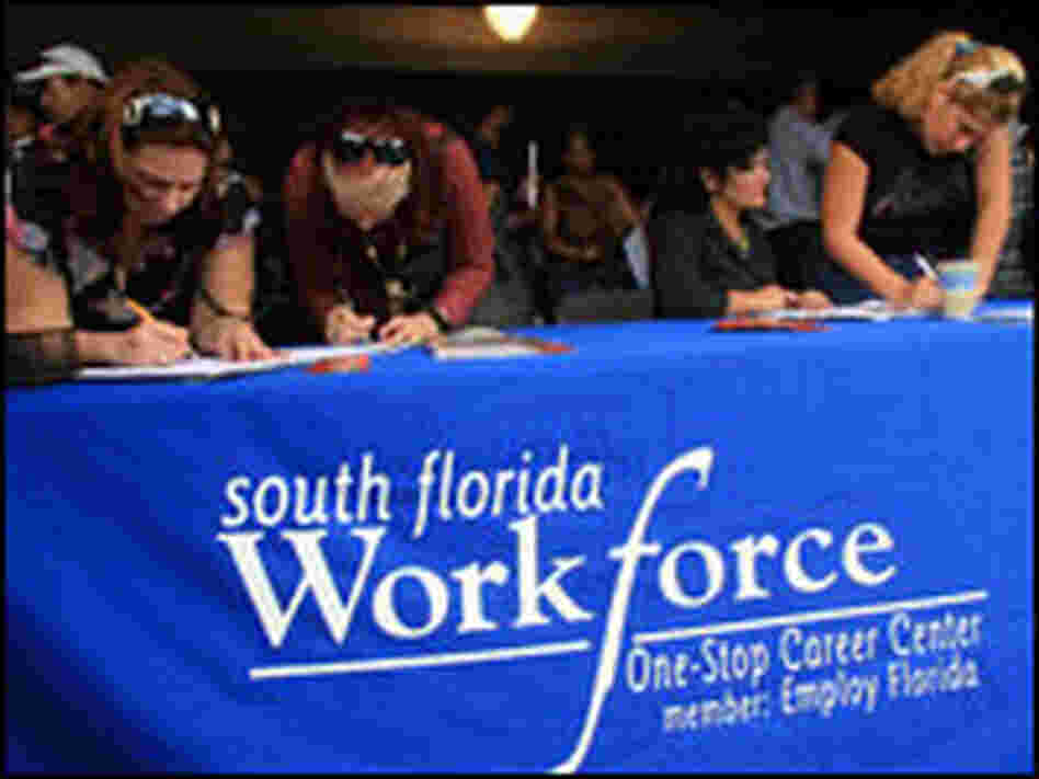 Job seekers register at a job fair attended by thousands Nov. 13 in Hialeah, Fla.