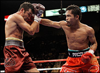 Manny Pacquiao throws a right at Oscar De La Hoya during the fourth round of their welterweight boxing match in Las Vegas on Saturday.