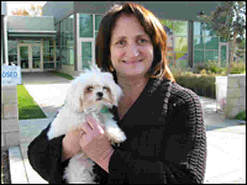 Debbie Garringer of Claremont, Calif., holds one of the two dogs she won at the auction. Debbie Garringer of Claremont, Calif., holds one of the two dogs she won at the auction.