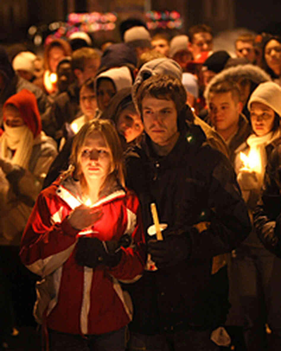 Students gather for a prayer service on the campus of Northern Illinois University to pray for those