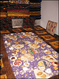 Food sits on a table in the room into which the newlyweds will move.