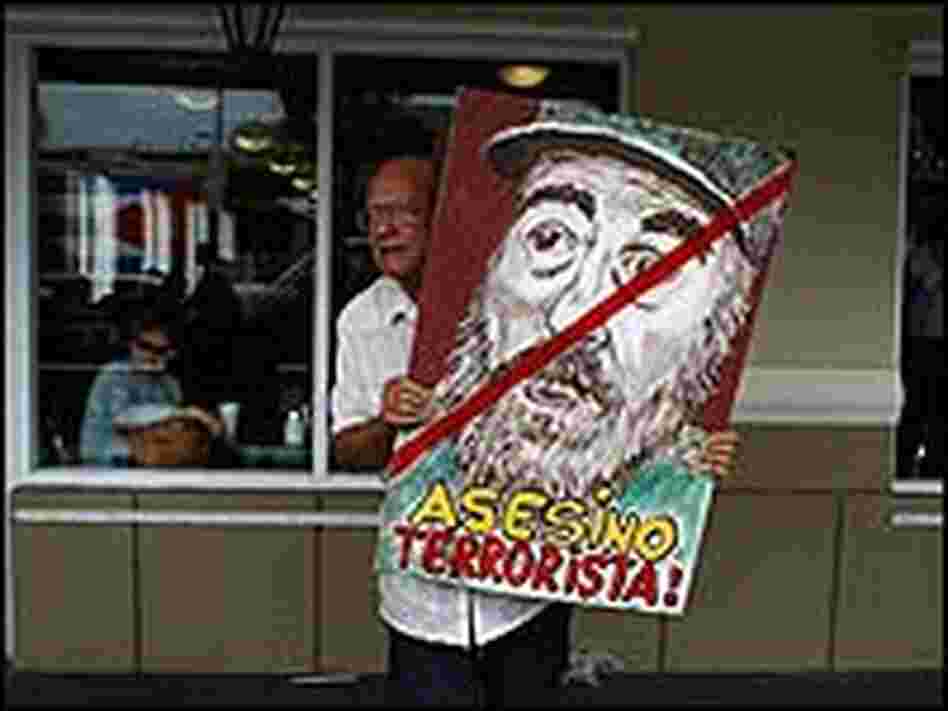 Alfredo Rey holds a painting of Cuban President Fidel Castro Alfredo Rey holds a painting of Cuban President Fidel Castro