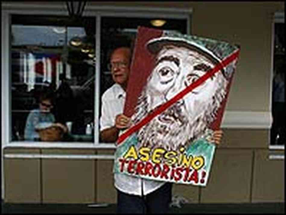 Alfredo Rey holds a painting of Cuban President Fidel Castro Alfredo Rey holds a painting of Cuban President Fidel Castro