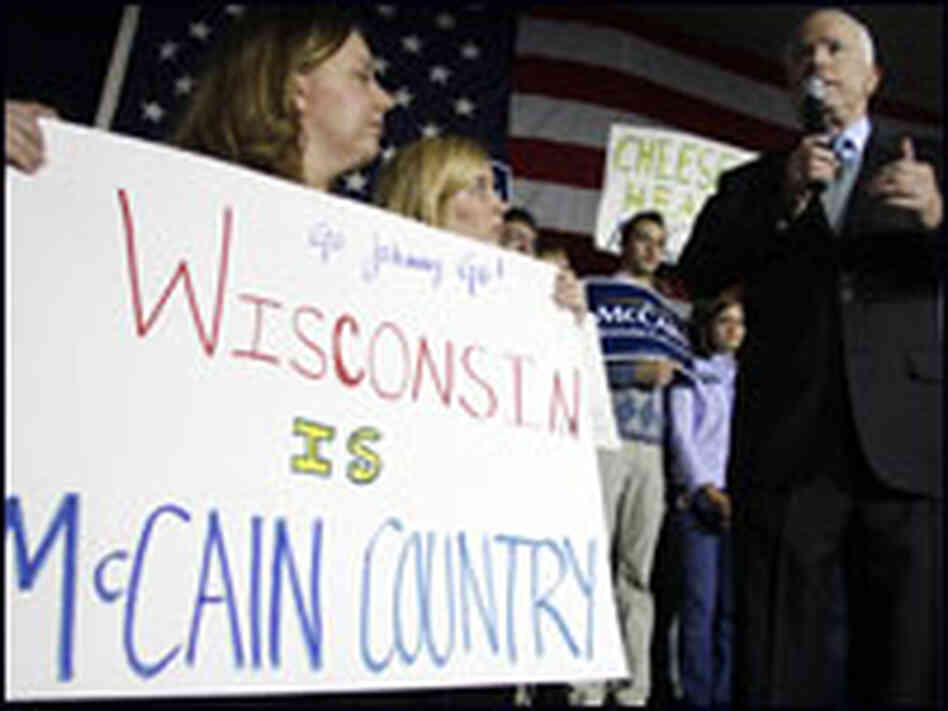 A supporter holds up a sign as John McCain speaks at a rally in Brookfield, Wis.