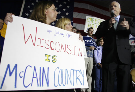 A supporter holds up a sign as John McCain speaks at a rally in Brookfield, Wis.