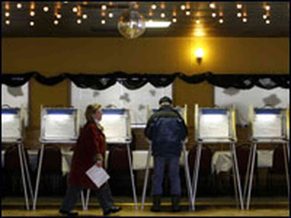 A woman walks away from a voting booth in Cedarburg, Wis.