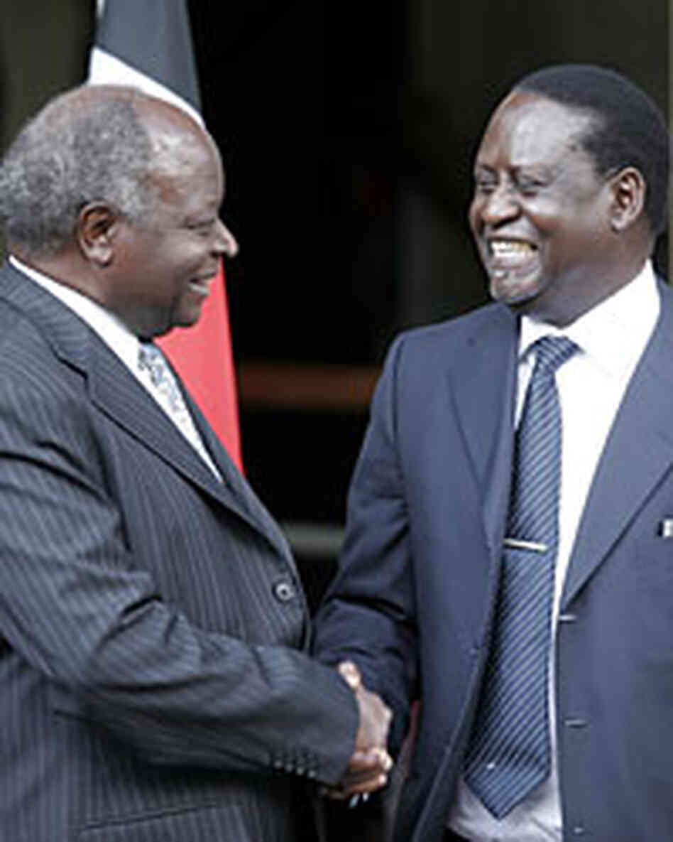 Kibaki (left) and Odinga shake hands after signing the deal. Kibaki (left) and Odinga shake hands after signing the deal.