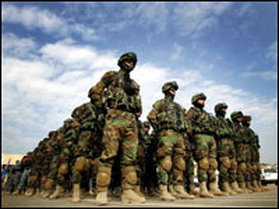 Iraqi police officers line up in formation.