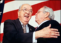  Sen. Jesse Helms of North Carolina (left) is congratulated by Sen. Lauch Faircloth on Nov. 5, 1996, after Helms won his fifth term to the Senate.