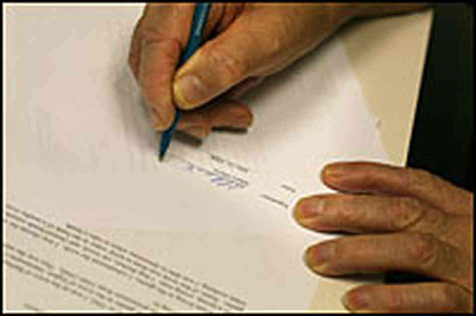 Albert Davis signing application papers Albert Davis signing application papers