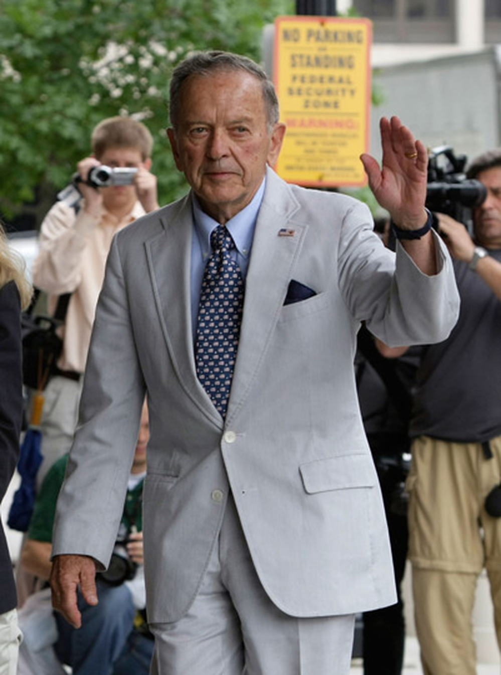 U.S. Sen. Ted Stevens waves to cameras as he arrives at the U.S. District Court in Washington, D.C.