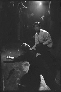 A wounded Kennedy lies on the kitchen floor.
