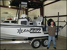 Sgt. Chris Sears and a river patrol boat. Sgt. Chris Sears and a river patrol boat.