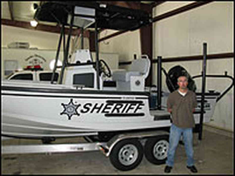 Sgt. Chris Sears and a river patrol boat.