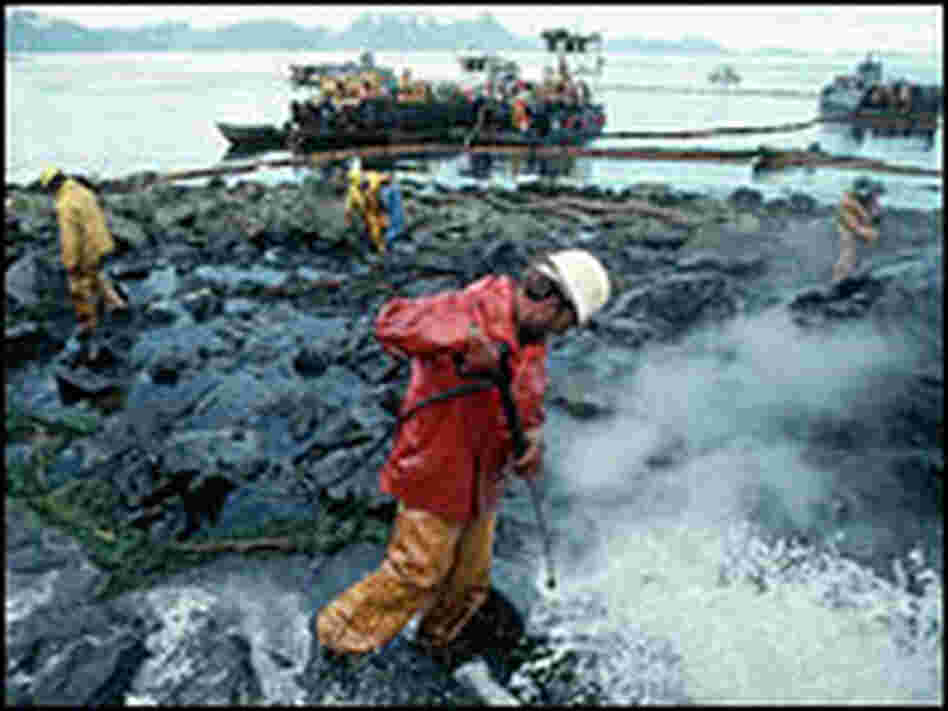 Workers clean oil-covered rocks in Alaska near the site of the Exxon Valdez oil spill in 1989.