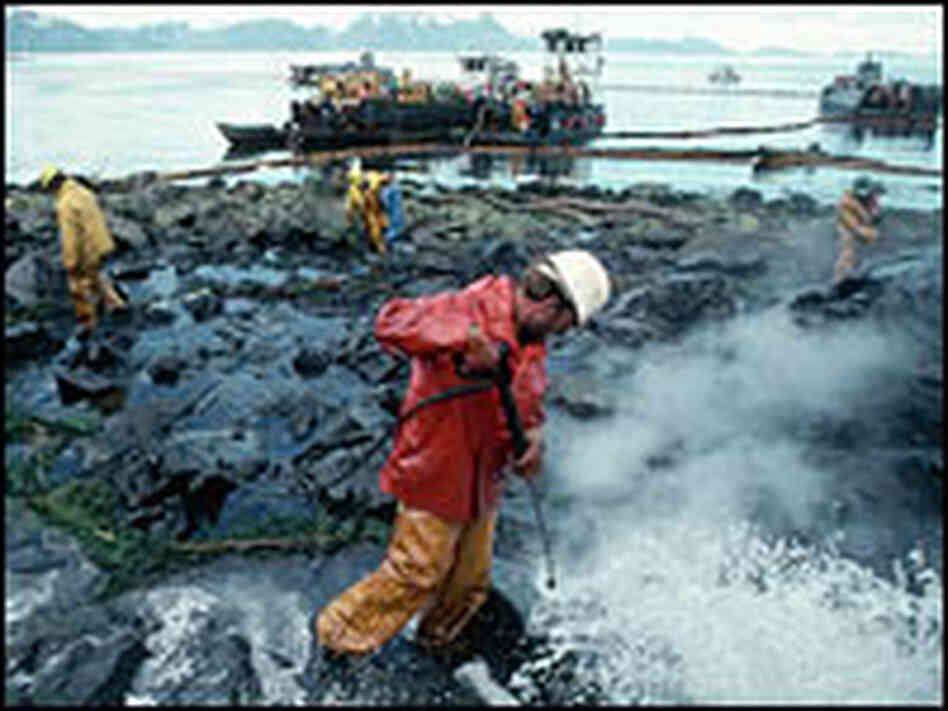 Workers clean oil-covered rocks in Alaska near the site of the Exxon Valdez oil spill in 1989.