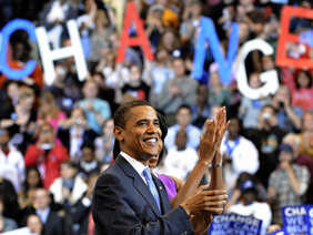 Illinois Sen. Barack Obama stands on stage with his wife, Michelle, during a primary day speech at the Xcel Energy Center in St. Paul, Minnesota, June 3, 2008. Emmanuel Dunand/AFP/Getty Images