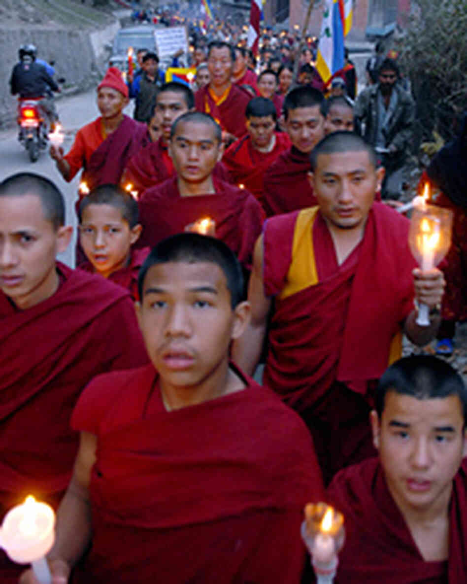 Tibetan protesters in exile hold a candlelight vigil as part of an anti-China demonstration. Tibetan protesters in exile hold a candlelight vigil as part of an anti-China demonstration.