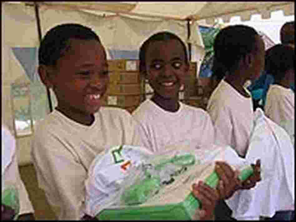 Some young girls smile after receiving their laptops.