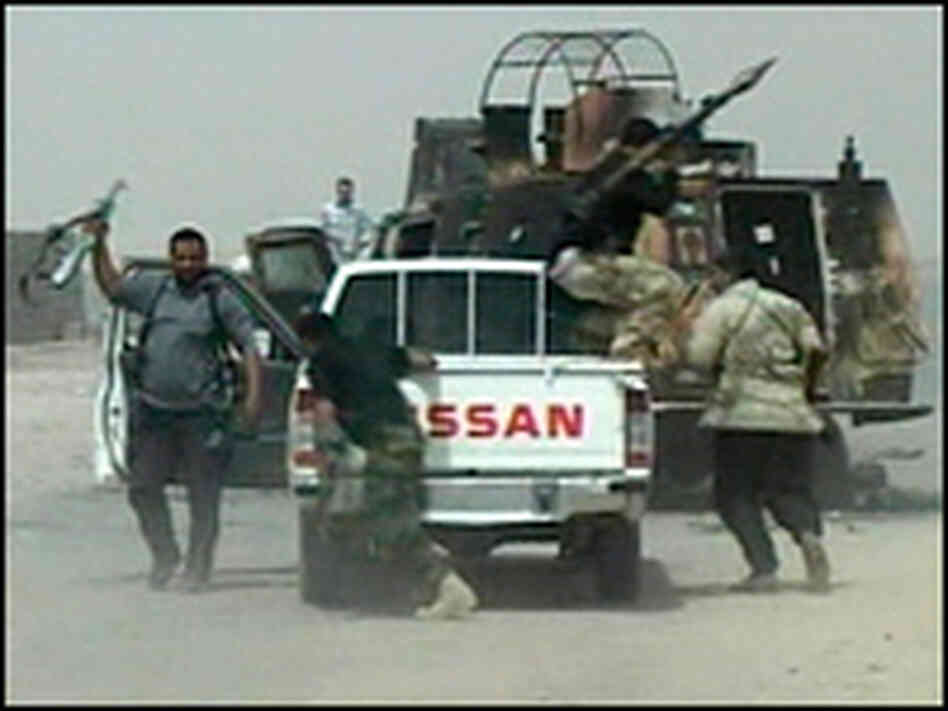 An image taken from video shows armed men in the southern oil port of Basra. An image taken from video shows armed men in the southern oil port of Basra.
