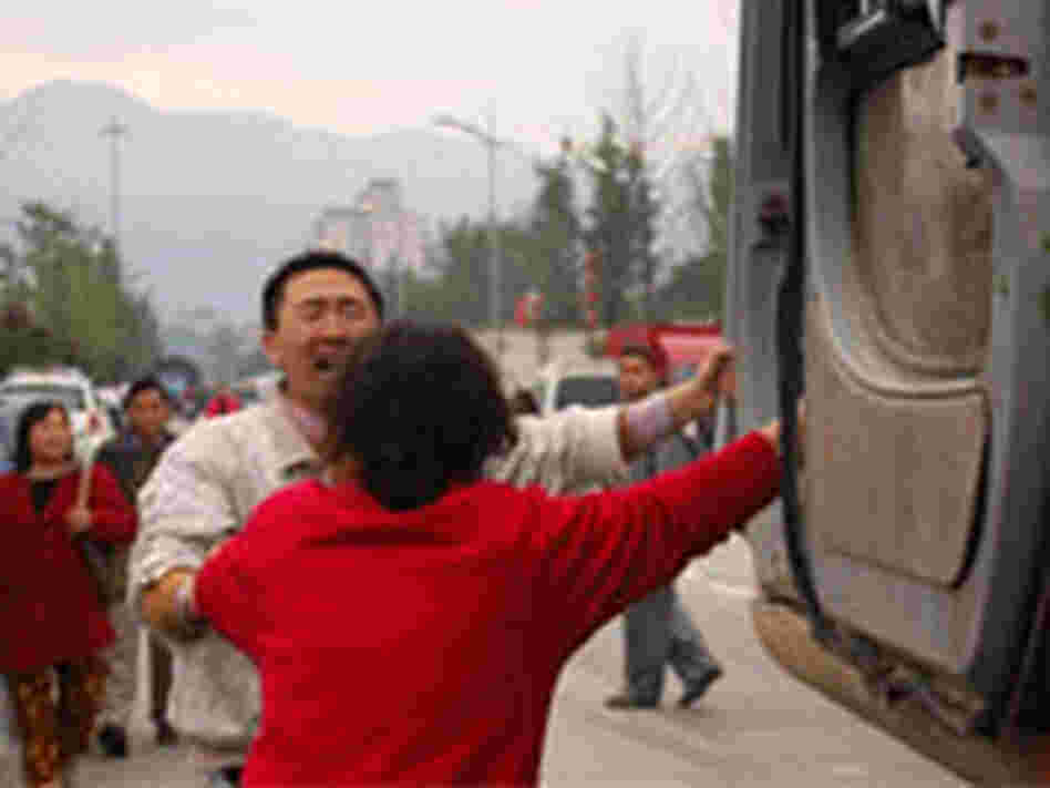 Wang Wei and Fu Guanyu beg the driver of an excavator rescue their family.