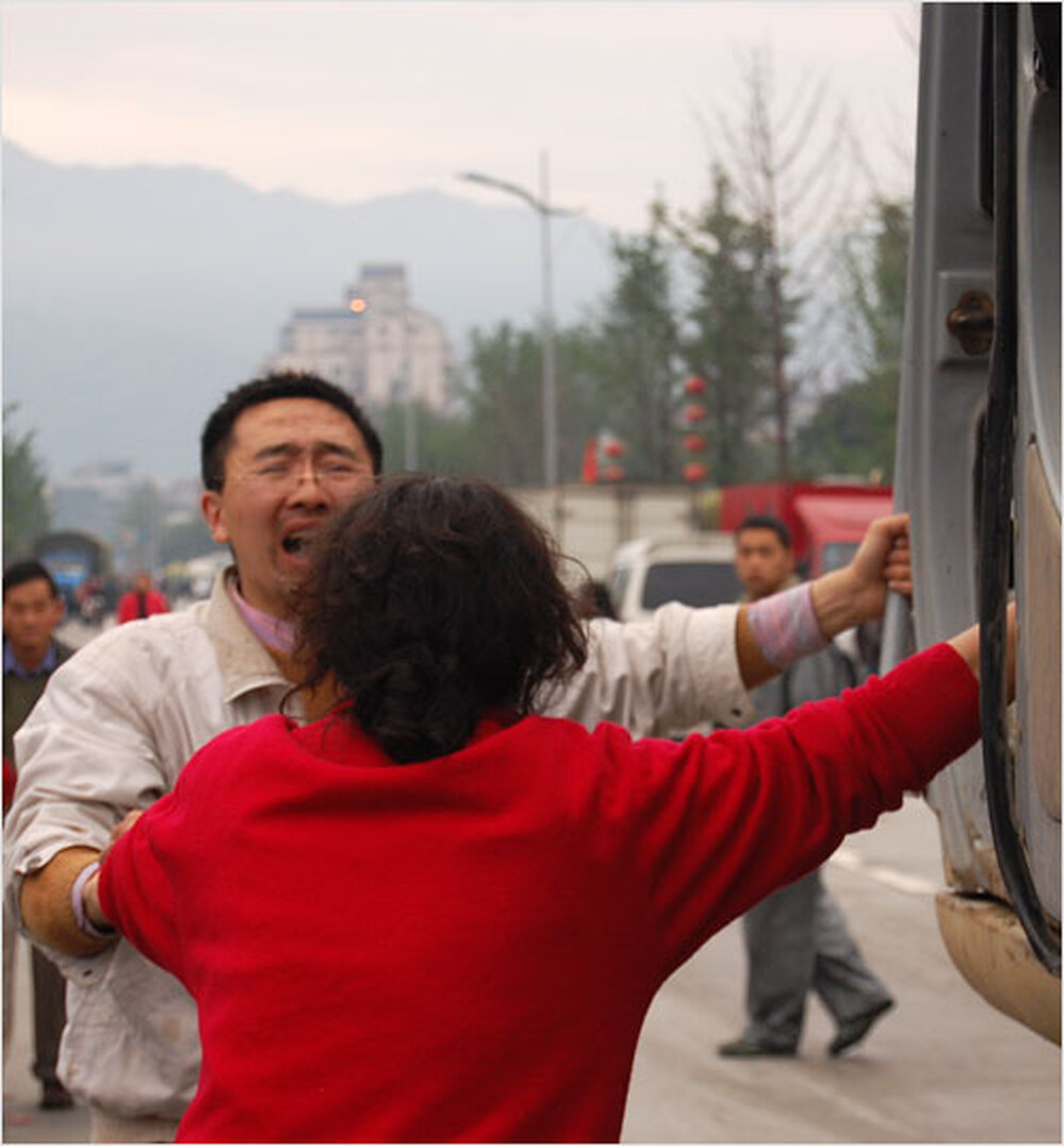 Wang Wei and Fu Guanyu beg the driver of an excavator rescue their family.