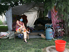 An earthquake survior rests in a shelter by a road on May 16, 2008 in Dujiangyan, one of the hard-hit cities, of Sichuan Province, China. (Photo by China Photos/Getty Images)