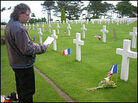 Jean Michel Miette pays his respects at Walter Malcolm's grave in an American cemetery. Jean Michel Miette pays his respects at Walter Malcolm's grave in an American cemetery.